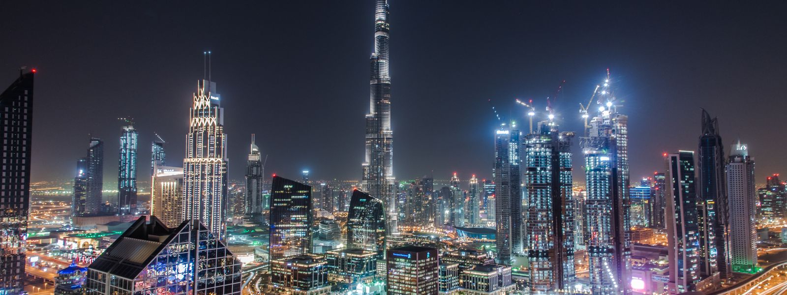 Dubai financial district at night with Burj Khalifa