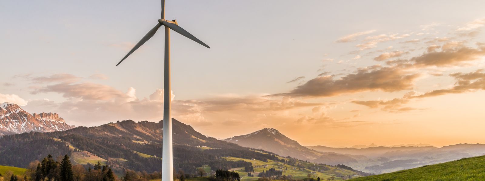 Wind turbine at sunset on Italian mountain landscape